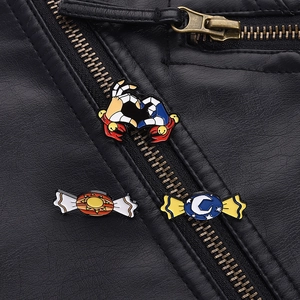 Close-up of anime candy enamel pins set on a black leather jacket with metal zippers