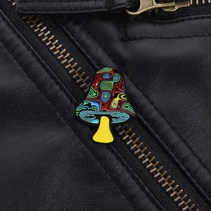 Close-up of colorful enamel mushroom brooch on a black leather jacket lapel accessory