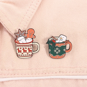 Close-up of Christmas enamel brooches featuring mugs with gingerbread man and snowman