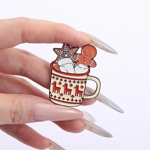 Christmas mug brooch with gingerbread man and marshmallow details on a white background