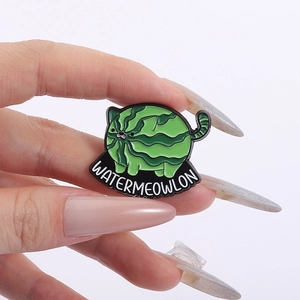 Detail of hand-held enamel pin featuring a green watermelon cat with Watermeowlon text