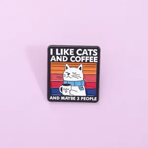 Detail of square cat enamel pin featuring coffee design and humorous text on purple background