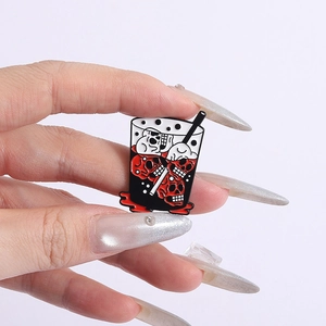 Close-up of gothic skeleton bubble tea enamel pin with red skulls and black finish