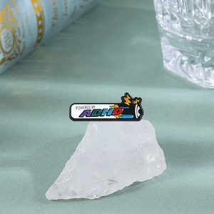 Creative enamel pin with battery shape and Powered by ADHD colorful text and lightning