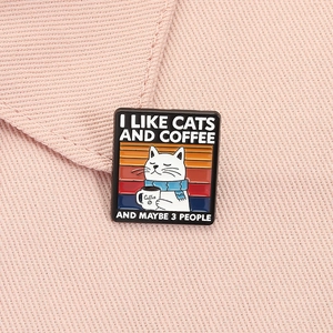 Detailed close-up of a cute cat coffee enamel pin pinned on pink twill fabric material