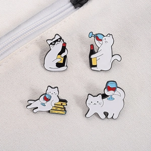 Detailed view of four cute cartoon cat enamel pins decorating a canvas tote bag