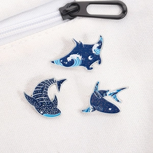 Whale shark and manta ray enamel pins set with ocean wave patterns on white canvas bag