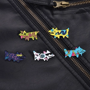 Close-up of five colorful geometric puppy enamel pins pinned on a black leather jacket