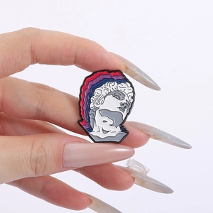 Artistic David sculpture enamel pin with colorful pop art waves held by fingers