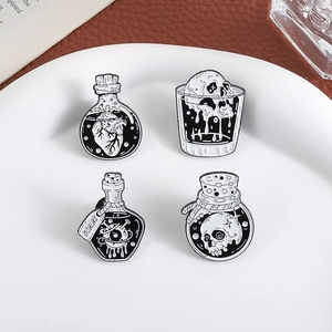 Gothic punk enamel pin set featuring anatomical heart and skull designs in black and white