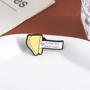 Fortune cookie enamel pin with Today is a fresh start quote on a white ceramic plate