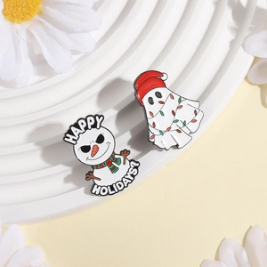Detail of Christmas enamel pins featuring a snowman and a ghost with holiday lights