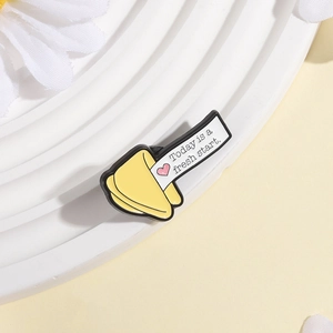 Creative cartoon fortune cookie enamel brooch with motivational phrase on white daisy background
