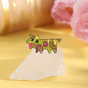 Macro detail of a colorful geometric enamel dog brooch pin on a decorative crystal base