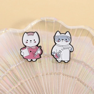 Detail of cute cat doctor and scientist enamel pins with syringe and chemical flask