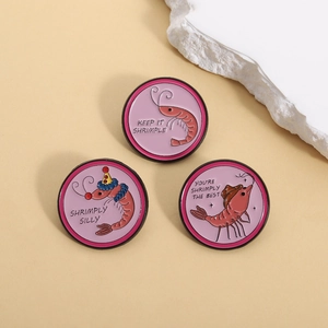 Funny shrimp enamel pin set with cartoon designs and puns on a warm background