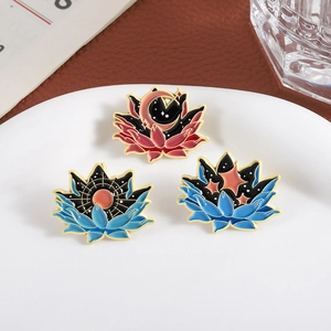 Three celestial lotus enamel pins featuring sun, moon, and stars on a white display plate