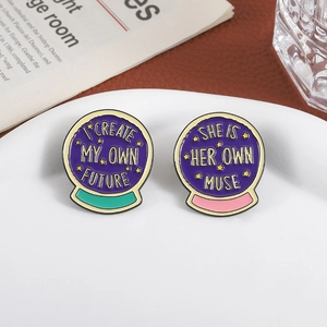 Inspirational crystal ball enamel pins set with self-motivation quotes on white plate
