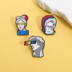 Artistic enamel pins featuring Greek sculptures with rainbow and pop art details