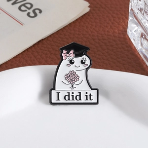 Cute Flork graduation enamel pin with I Did It text and pink flowers on white tray