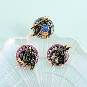 Gothic enamel pin set with black owl, bat and winged cat on a pearl shell tray
