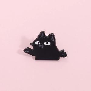 Cute black cat enamel brooch in humorous shrug pose, cartoon metal pin on pink background
