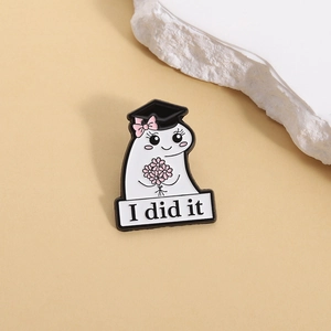 Cute ghost enamel graduation pin with a black cap, pink flowers, and I did it banner