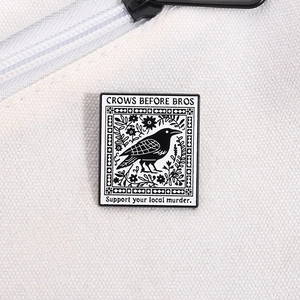 Funny enamel crow pin with Crows Before Bros slogan on white canvas background