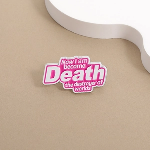 Pink enamel lapel pin with 'Now I am become Death' quote on a minimal background