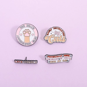 Set of four cute cat enamel pins featuring paw prints and fun animal patterns