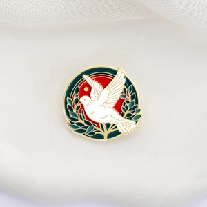 Enamel peace dove brooch with red sun and green olive branch on vintage gold pin