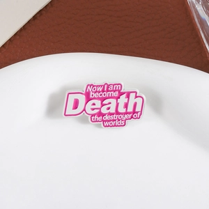Pink enamel brooch featuring 'Now I am become Death' quote with white lettering