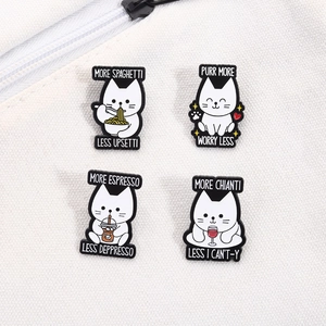 Vue détaillée de quatre épingles en émail de chats blancs avec jeux de mots sur toile