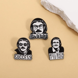 Three minimalist black and white enamel pins featuring male portraits with creative quotes