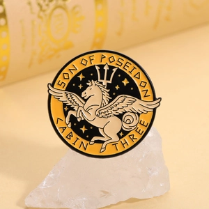 Macro detail of enamel Pegasus badge featuring Son of Poseidon and Cabin Three text