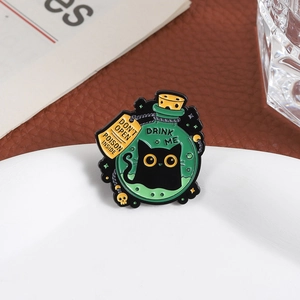 Gothic black cat poison bottle enamel pin with Drink Me text and green liquid design
