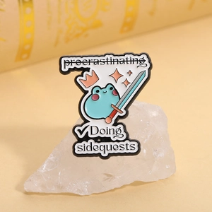 Close-up of a blue enamel frog knight pin featuring Sidequests text on white crystal