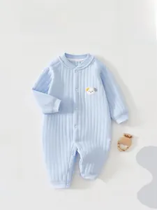 Close-up of light blue ribbed cotton baby romper with cute dog embroidery and snap buttons