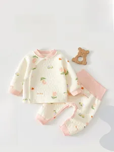 Detail of baby thermal quilted cotton suit with pink ribbed cuffs and lucky floral print