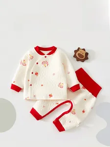 Detail of infant quilted thermal set with traditional red lanterns and koi fish patterns