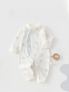 Detail of baby cotton romper featuring side snap buttons and colorful balloon pattern