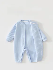Detail of baby warm romper featuring snap buttons and soft blue striped cotton fabric