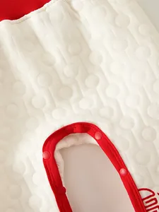 Detail of snap buttons and quilted cotton fabric on baby warm pants for easy dressing