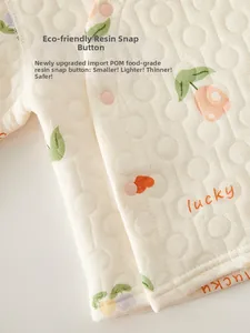 Detail of baby quilted fabric featuring lucky tulip print and safe pink snap buttons