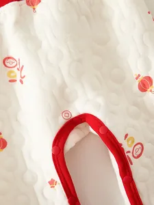 Detailed quilted fabric of newborn cotton bodysuit with red lantern and fu character