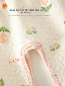 Detail of baby quilted cotton pants showing pink crotch snap buttons and floral lucky print
