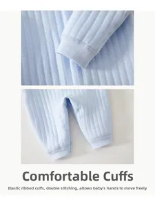 Detail of baby cotton jumpsuit showing elastic ribbed cuffs and durable double-stitched seams