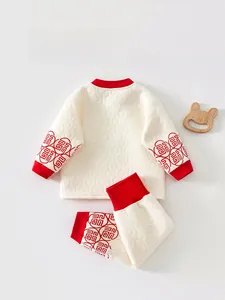 Detail view of quilted baby thermal set with red ribbed cuffs and Chinese pattern trim