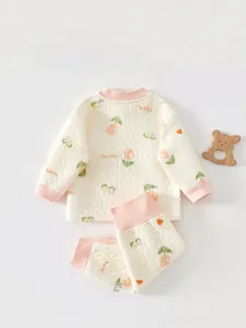 Close-up of quilted cotton baby sleepwear with pink edges and flower prints