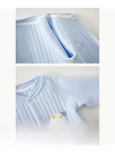 Detailed view of seamless stitching and cartoon puppy patch on baby cotton romper